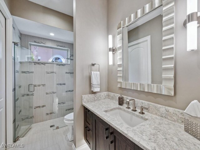 14822 Bellezza Ln, Naples, FL 34110 - full bath featuring a stall shower, vanity, and toilet