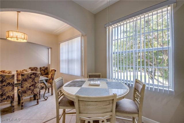5912 Tarpon Gardens Cir Unit 201, Cape Coral, FL 33914 - dining space with arched walkways, healthy amount of natural light, and light tile patterned floors