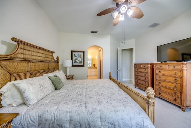 5912 Tarpon Gardens Cir Unit 201, Cape Coral, FL 33914 - bedroom with arched walkways, carpet, a ceiling fan, and connected bathroom