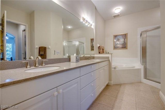 5912 Tarpon Gardens Cir Unit 201, Cape Coral, FL 33914 - bathroom with double vanity, a shower stall, a bath, and tile patterned flooring