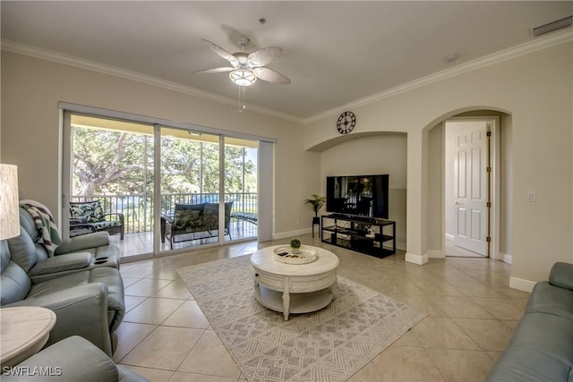 5912 Tarpon Gardens Cir Unit 201, Cape Coral, FL 33914 - living area with light tile patterned floors, crown molding, a ceiling fan, arched walkways, and baseboards