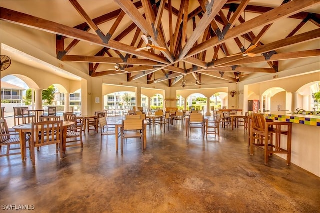 5912 Tarpon Gardens Cir Unit 201, Cape Coral, FL 33914 - dining area with high vaulted ceiling, concrete floors, healthy amount of natural light, and beam ceiling