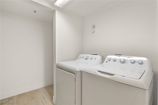 16410 Kelly Cove Dr Unit 313, Fort Myers, FL 33908 - laundry area featuring washer and clothes dryer, light wood finished floors, and baseboards