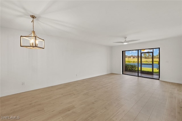 16410 Kelly Cove Dr Unit 313, Fort Myers, FL 33908 - spare room featuring light wood finished floors, a ceiling fan, and a chandelier