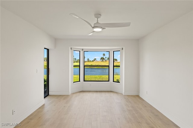 16410 Kelly Cove Dr Unit 313, Fort Myers, FL 33908 - unfurnished room featuring light wood finished floors, ceiling fan, a water view, and baseboards