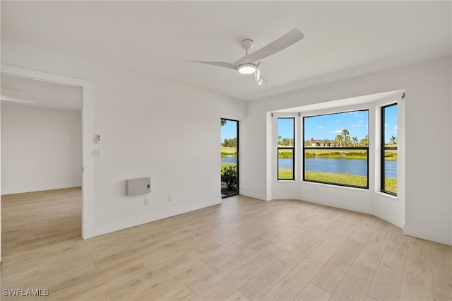 16410 Kelly Cove Dr Unit 313, Fort Myers, FL 33908 - empty room featuring a ceiling fan, light wood-type flooring, and a water view