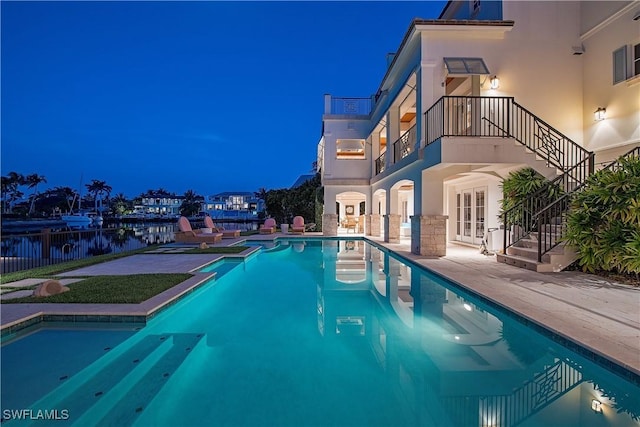 2001 4th St S, Naples, FL 34102 - view of pool with french doors, stairs, a patio area, a water view, and a pool with connected hot tub