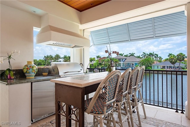 2001 4th St S, Naples, FL 34102 - view of patio featuring exterior kitchen and a water view