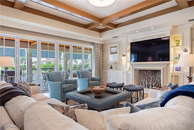 2001 4th St S, Naples, FL 34102 - living room with beamed ceiling, coffered ceiling, a decorative wall, a fireplace, and ornamental molding