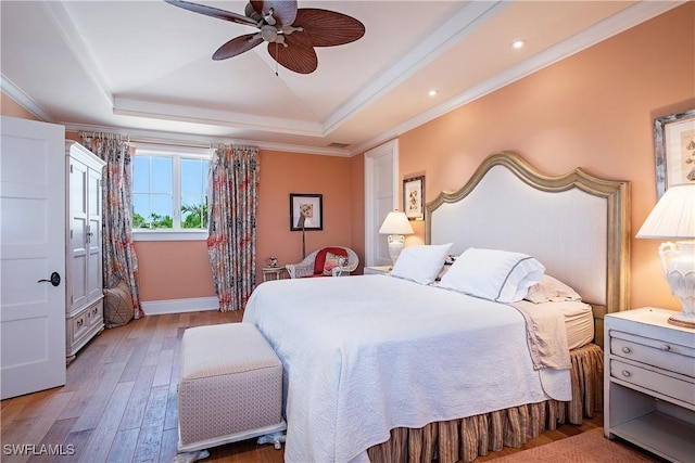 2001 4th St S, Naples, FL 34102 - bedroom featuring a tray ceiling, light wood finished floors, ornamental molding, recessed lighting, and a ceiling fan