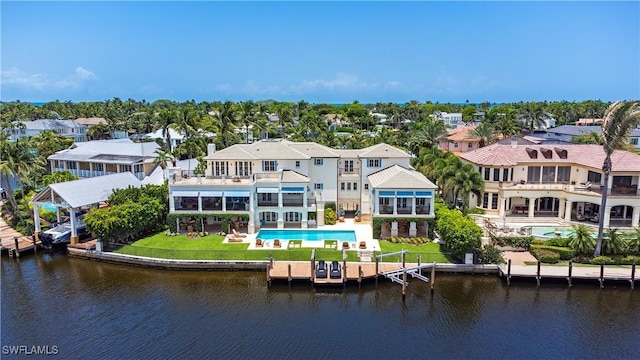 2001 4th St S, Naples, FL 34102 - rear view of house featuring a balcony, an outdoor pool, a residential view, a patio area, and a yard