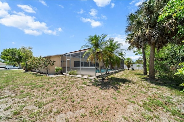 1237 SE 24th Ave Unit A, Cape Coral, FL 33990 - view of grassy yard featuring glass enclosure and an outdoor pool