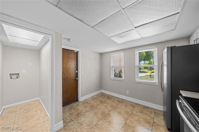1237 SE 24th Ave Unit A, Cape Coral, FL 33990 - kitchen featuring stainless steel range, light tile patterned flooring, and baseboards