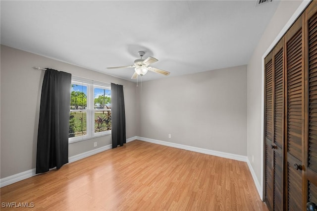 1237 SE 24th Ave Unit A, Cape Coral, FL 33990 - unfurnished bedroom featuring light wood-style flooring, a closet, baseboards, and a ceiling fan