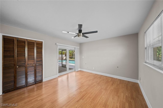 1237 SE 24th Ave Unit A, Cape Coral, FL 33990 - unfurnished bedroom with access to exterior, light wood-type flooring, baseboards, and a closet