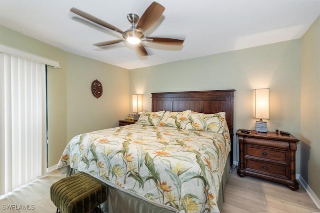 12581 Kelly Sands Way Unit 525, Fort Myers, FL 33908 - bedroom with light wood-style flooring, baseboards, and a ceiling fan