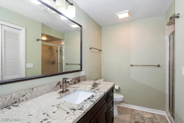 12581 Kelly Sands Way Unit 525, Fort Myers, FL 33908 - full bath featuring toilet, a shower stall, vanity, wood finished floors, and baseboards