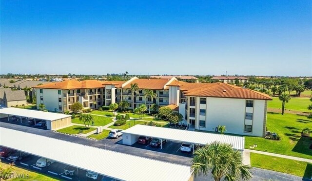 12581 Kelly Sands Way Unit 525, Fort Myers, FL 33908 - view of front of house with covered and uncovered parking