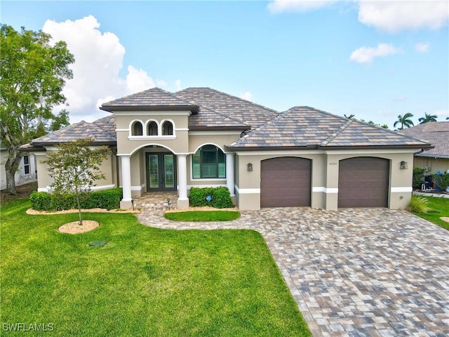 4324 SW 26th Ave, Cape Coral, FL 33914 - view of front of property with french doors, a garage, a front lawn, and stucco siding