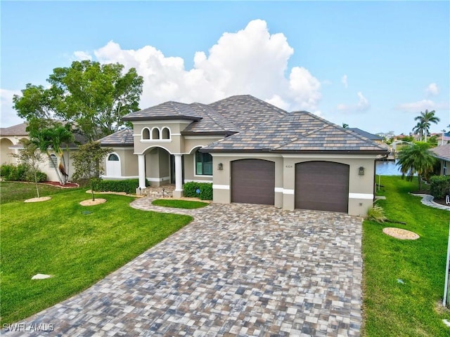 4324 SW 26th Ave, Cape Coral, FL 33914 - view of front of property with stucco siding, a garage, a front lawn, and decorative driveway