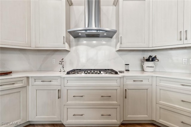 4324 SW 26th Ave, Cape Coral, FL 33914 - kitchen with island exhaust hood, stainless steel gas cooktop, decorative backsplash, and light countertops