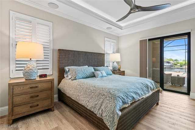4324 SW 26th Ave, Cape Coral, FL 33914 - bedroom featuring access to exterior, light wood-style flooring, ornamental molding, a raised ceiling, and baseboards
