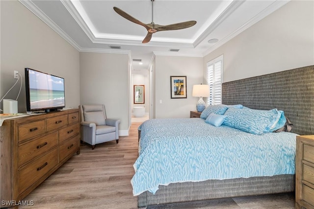 4324 SW 26th Ave, Cape Coral, FL 33914 - bedroom featuring light wood-style floors, a tray ceiling, ornamental molding, ceiling fan, and connected bathroom