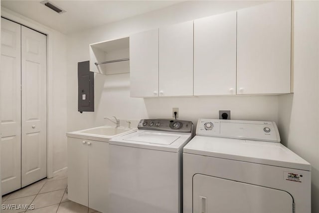 14550 Red Fox Run Unit 407, Naples, FL 34110 - washroom with electric panel, separate washer and dryer, cabinet space, and light tile patterned floors