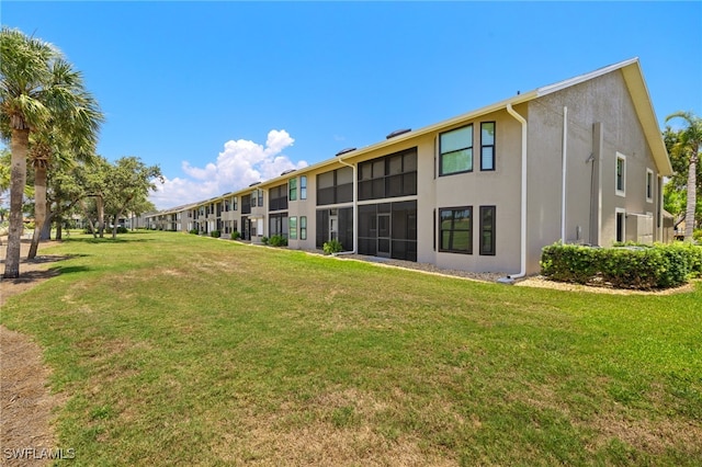 16260 Kelly Cove Dr Unit 235, Fort Myers, FL 33908 - rear view of house with stucco siding and a yard