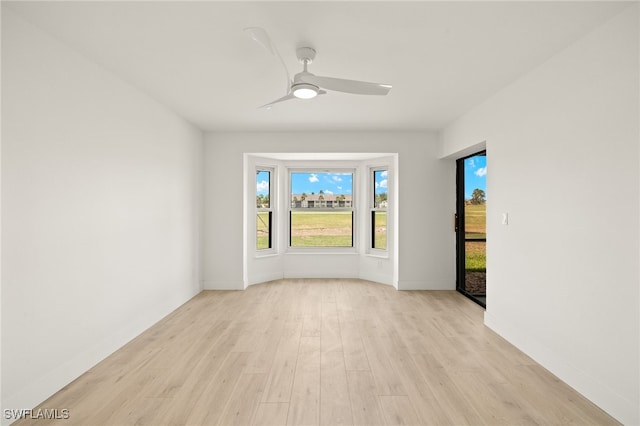 16260 Kelly Cove Dr Unit 235, Fort Myers, FL 33908 - spare room with light wood-style flooring, a ceiling fan, and baseboards