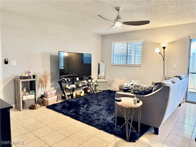 5751 Foxlake Dr Unit A, North Fort Myers, FL 33917 - living room featuring ceiling fan, tile patterned flooring, and a textured ceiling