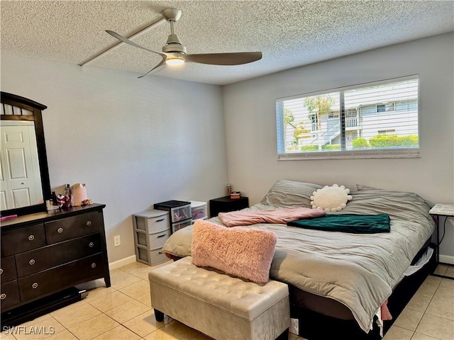 5751 Foxlake Dr Unit A, North Fort Myers, FL 33917 - bedroom with light tile patterned floors, a ceiling fan, and a textured ceiling