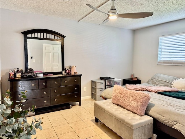 5751 Foxlake Dr Unit A, North Fort Myers, FL 33917 - bedroom featuring tile patterned floors, a textured ceiling, and a ceiling fan