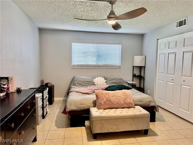 5751 Foxlake Dr Unit A, North Fort Myers, FL 33917 - bedroom with a closet, light tile patterned flooring, a ceiling fan, and a textured ceiling