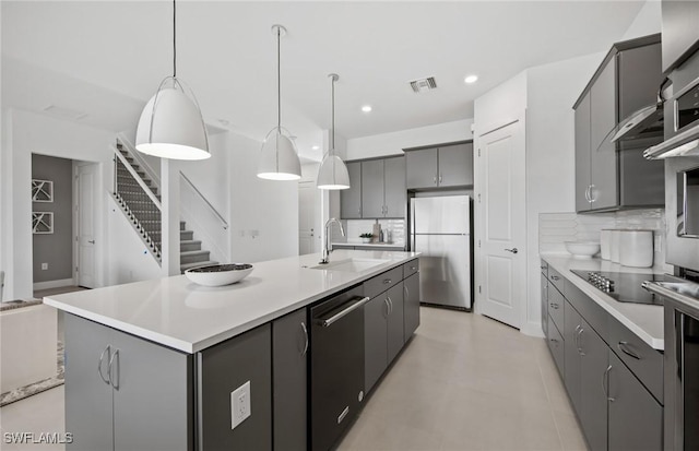 12412 Basalt Ln, Alva, FL 33982 - kitchen featuring a sink, dishwasher, freestanding refrigerator, tasteful backsplash, and gray cabinets