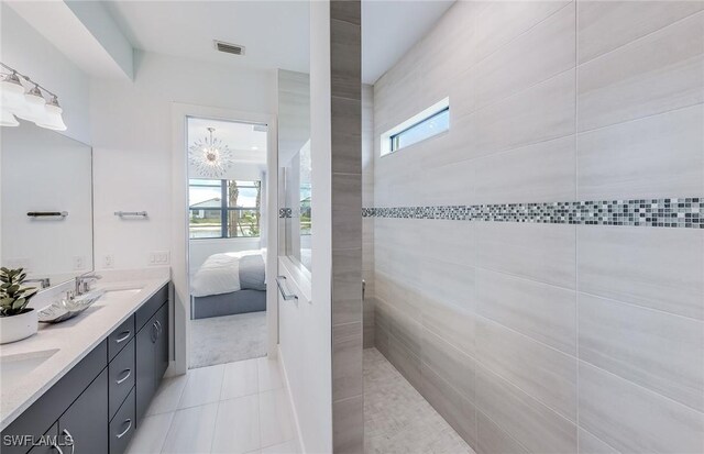 12412 Basalt Ln, Alva, FL 33982 - ensuite bathroom with double vanity, plenty of natural light, and tile patterned floors
