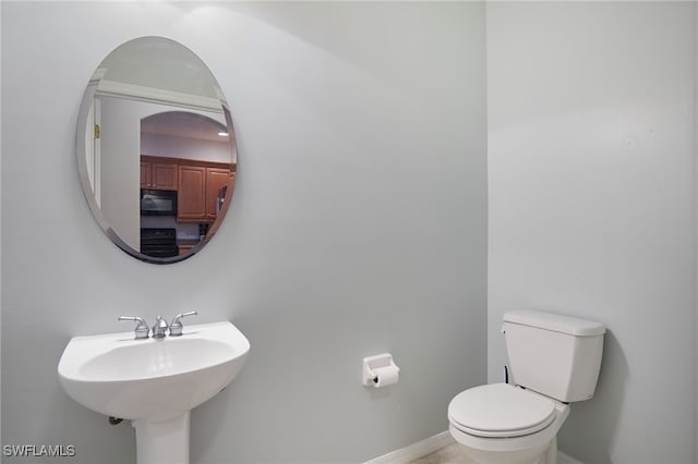 4381 Lazio Way Unit 504, Fort Myers, FL 33901 - bathroom featuring toilet, baseboards, and a sink