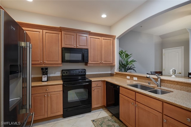 4381 Lazio Way Unit 504, Fort Myers, FL 33901 - kitchen with black appliances, a sink, light tile patterned flooring, recessed lighting, and light stone counters