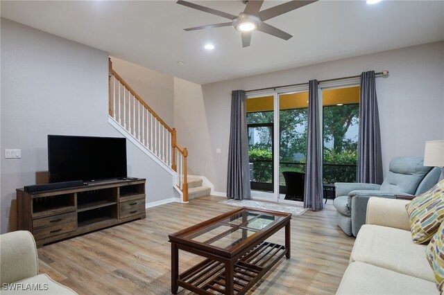 4381 Lazio Way Unit 504, Fort Myers, FL 33901 - living room with stairway, light wood-style floors, ceiling fan, recessed lighting, and baseboards