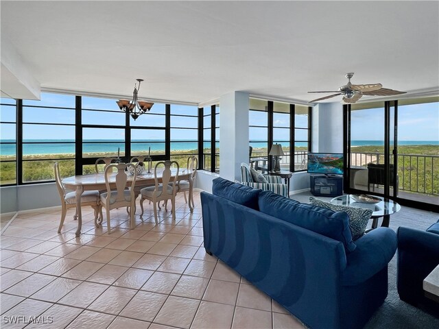 440 Seaview Ct Unit 1012, Marco Island, FL 34145 - living area with light tile patterned floors, a chandelier, floor to ceiling windows, a water view, and baseboards