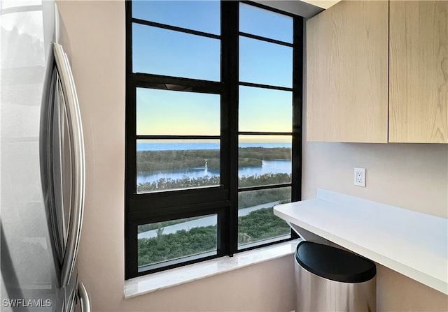 440 Seaview Ct Unit 1012, Marco Island, FL 34145 - kitchen featuring freestanding refrigerator, light brown cabinetry, modern cabinets, light countertops, and a water view