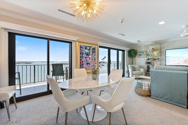 1100 S Collier Blvd Unit 1025, Marco Island, FL 34145 - carpeted dining area with ornamental molding, a water view, and a chandelier