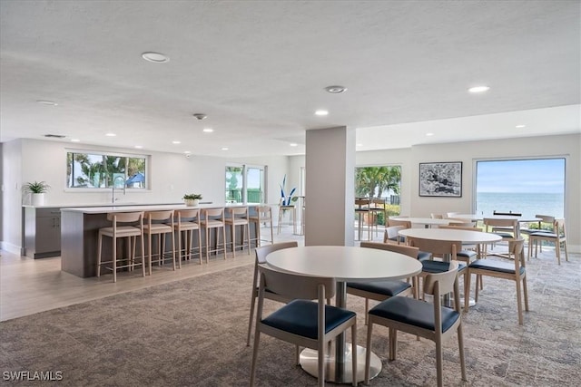 1100 S Collier Blvd Unit 1025, Marco Island, FL 34145 - dining room featuring plenty of natural light, recessed lighting, light carpet, and light wood-type flooring