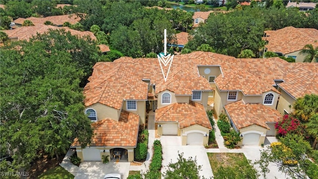 96 Silver Oaks Cir Unit 1-202, Naples, FL 34119 - view of front of home with concrete driveway, stucco siding, and an attached garage