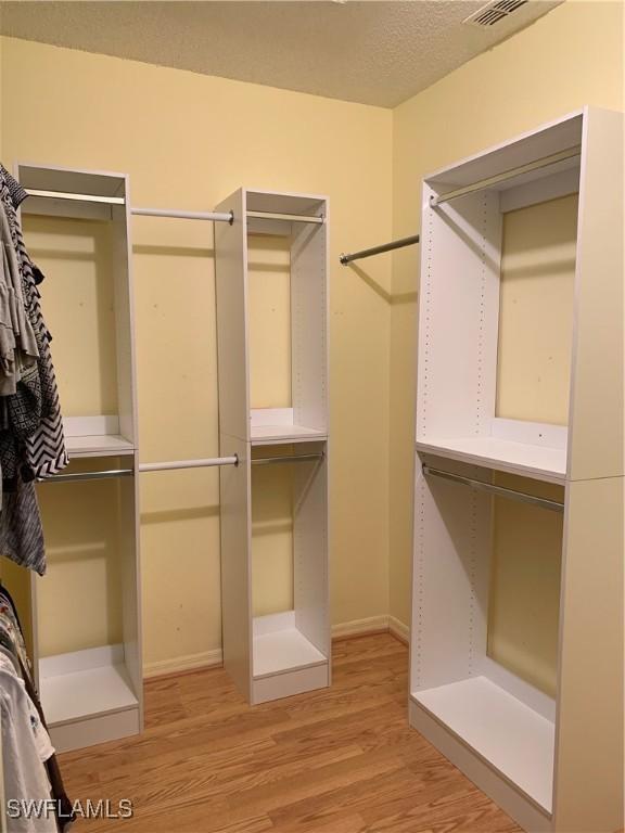96 Silver Oaks Cir Unit 1-202, Naples, FL 34119 - spacious closet with light wood finished floors