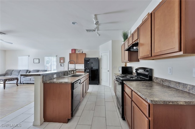 4326 SW 9th Ave, Cape Coral, FL 33914 - kitchen featuring black appliances, a sink, under cabinet range hood, dark countertops, and brown cabinetry
