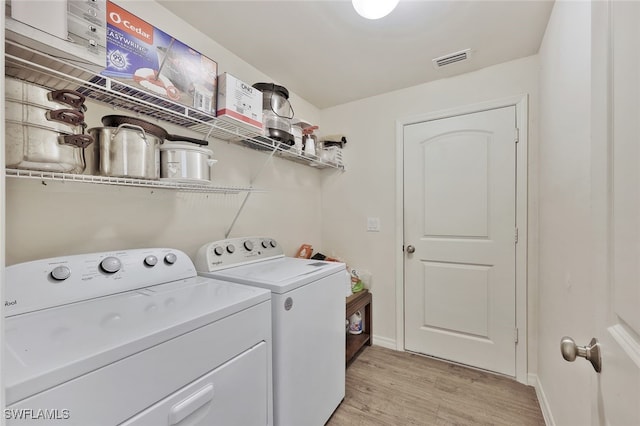 4326 SW 9th Ave, Cape Coral, FL 33914 - laundry room featuring washing machine and dryer, light wood-style floors, and baseboards