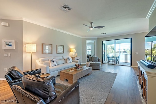 3153 Aviamar Cir Unit 202, Naples, FL 34114 - living room featuring wood finished floors, a ceiling fan, crown molding, and baseboards