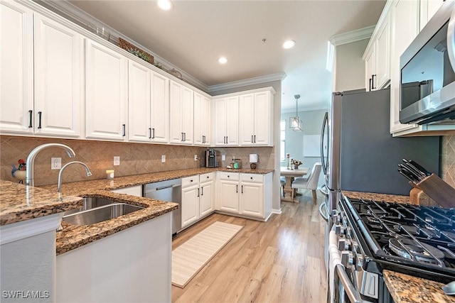 3153 Aviamar Cir Unit 202, Naples, FL 34114 - kitchen with stainless steel appliances, ornamental molding, light wood finished floors, white cabinets, and a sink