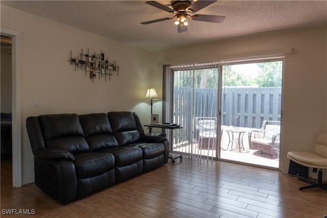 1165 Palm Ave Unit 8A, North Fort Myers, FL 33903 - living area featuring wood finished floors, a textured ceiling, and ceiling fan